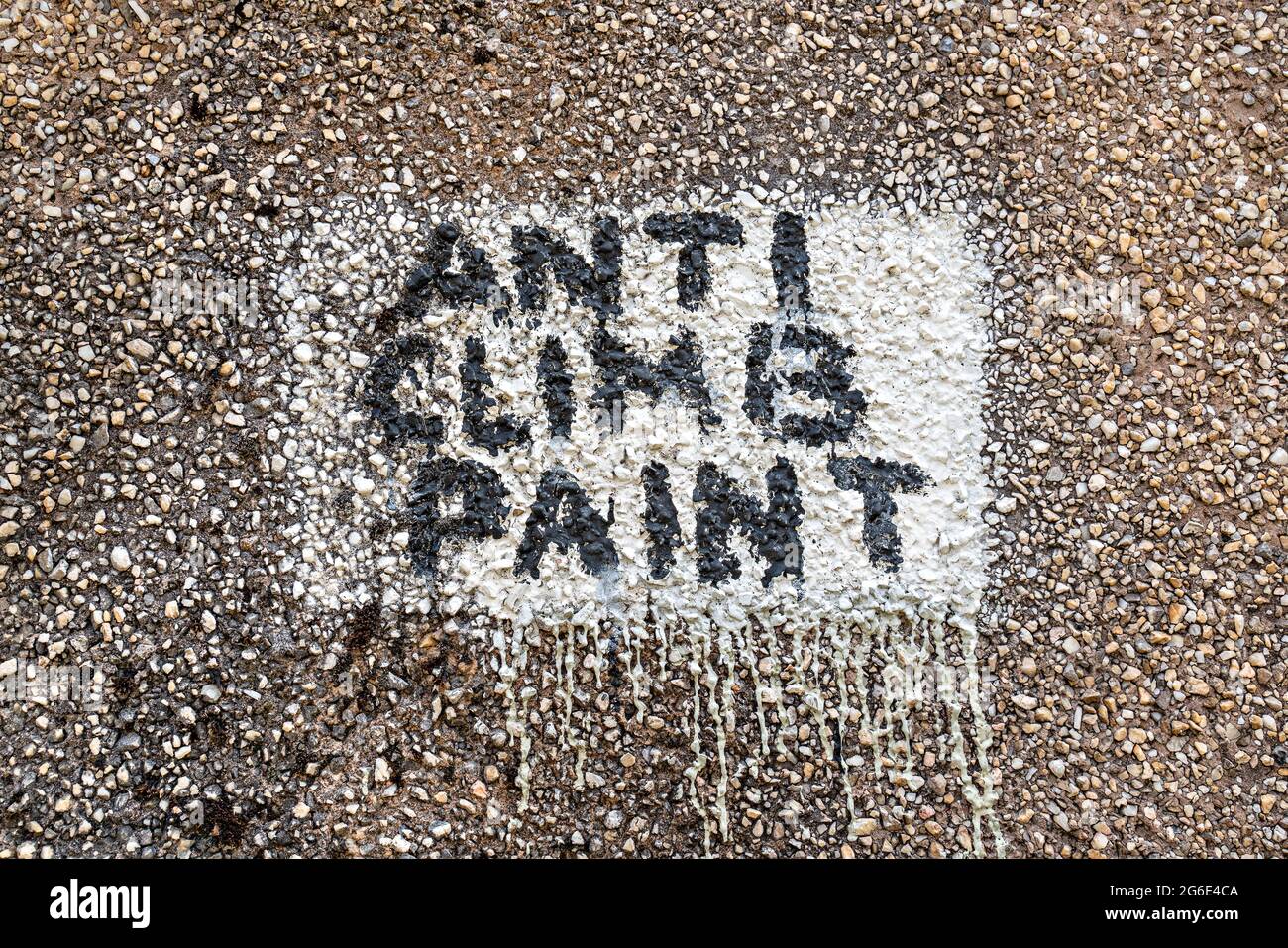 Anti Climb Paint, warning painted on pebbledash wall Stock Photo