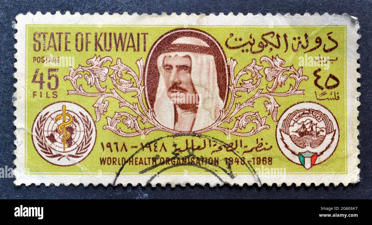 Cancelled postage stamp printed by Kuwait, that shows Sheik Sabah, Arms