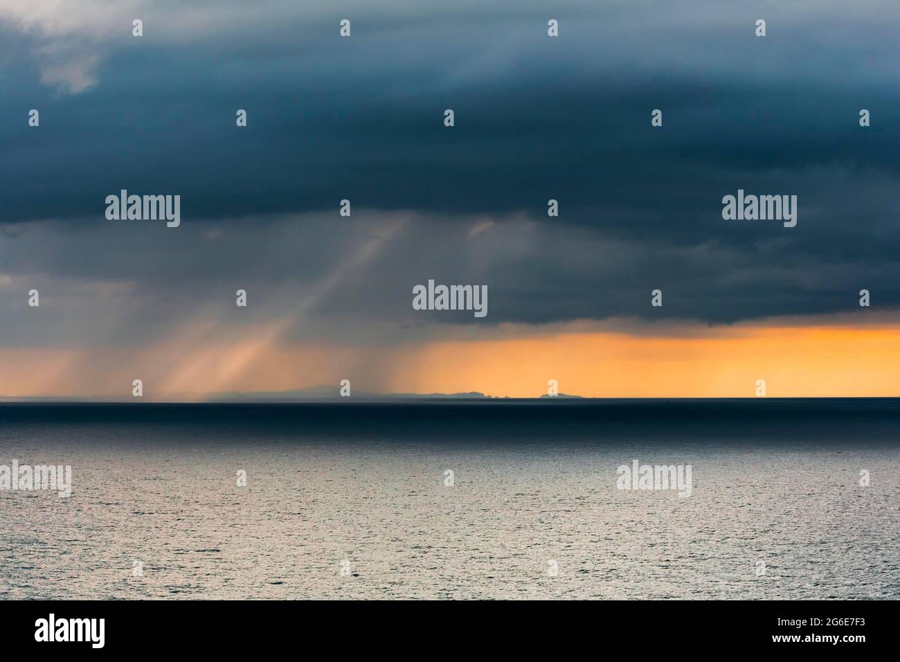Rain clouds at sunset, Fletcher Bay, Coromandel, North Island, New Zealand Stock Photo