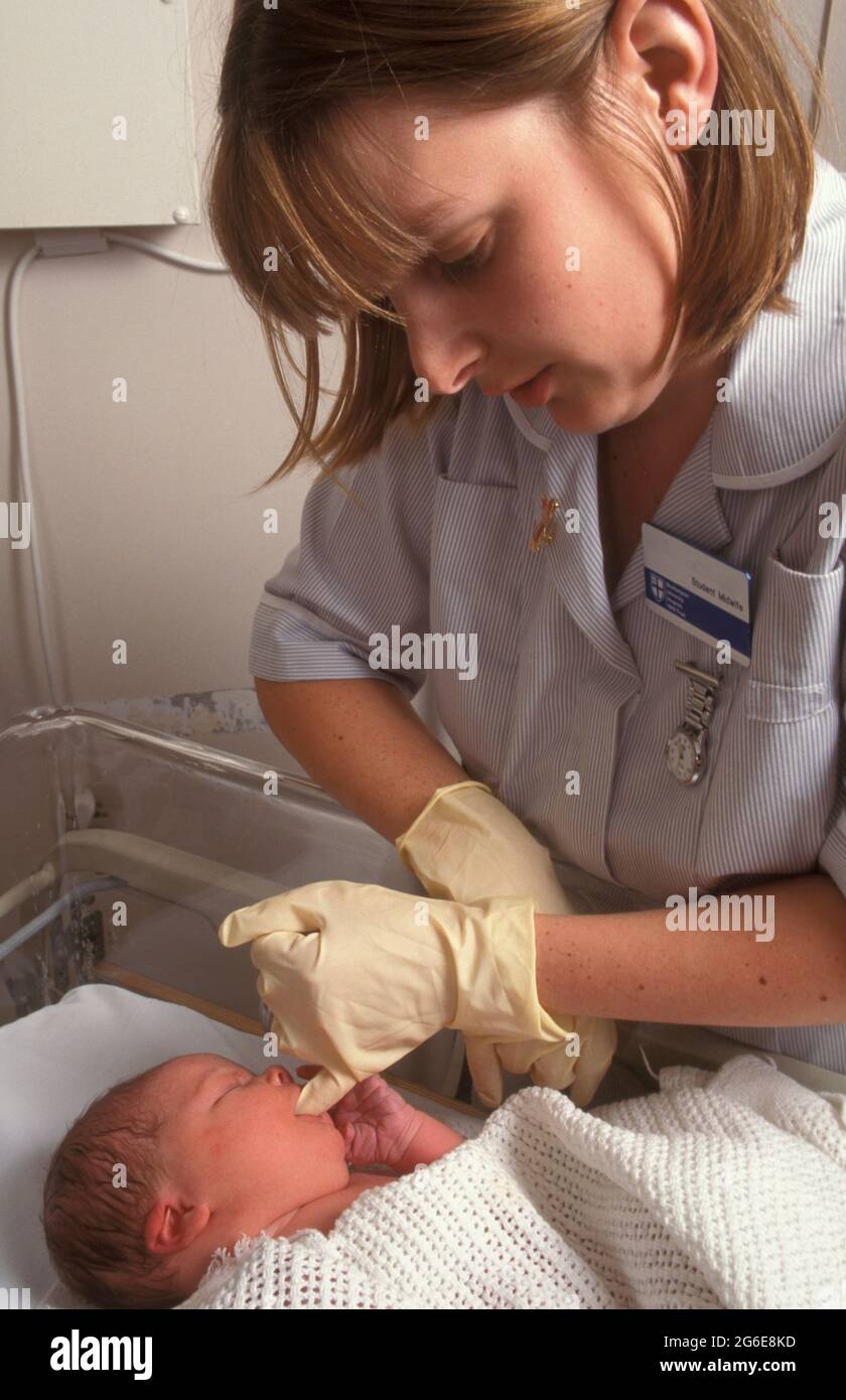 young midwife performing ante natal checks (cleft palate) on newborn baby Stock Photo