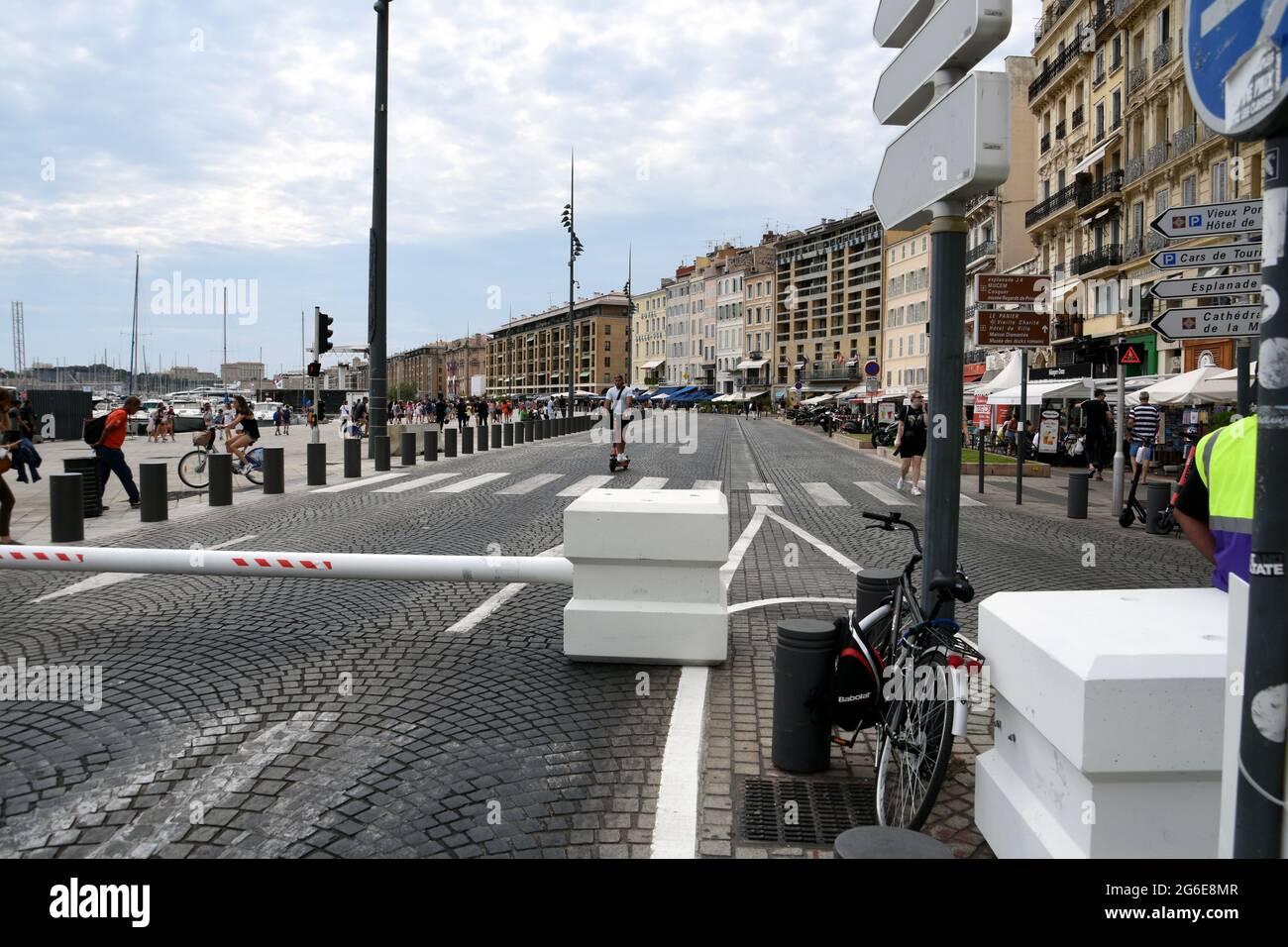 Marseille, France. 03rd July, 2021. A man on a scooter behind a barrier preventing vehicles from entering the Quai du Port.The city hall of Marseille will test for two months the pedestrianization of part of the Vieux-Port. Credit: SOPA Images Limited/Alamy Live News Stock Photo
