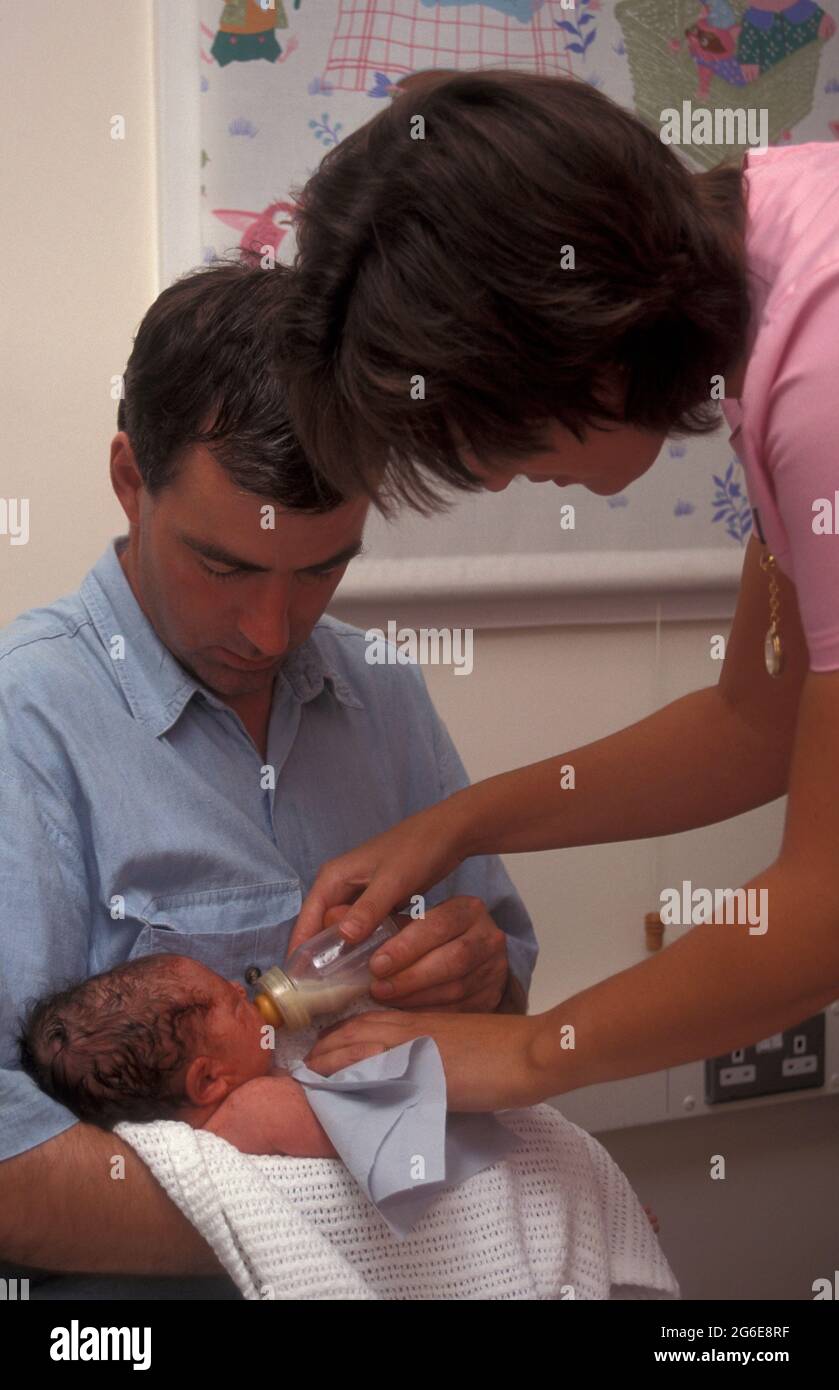 nurse or midwife showing father how to bottlefeed mothers expressed