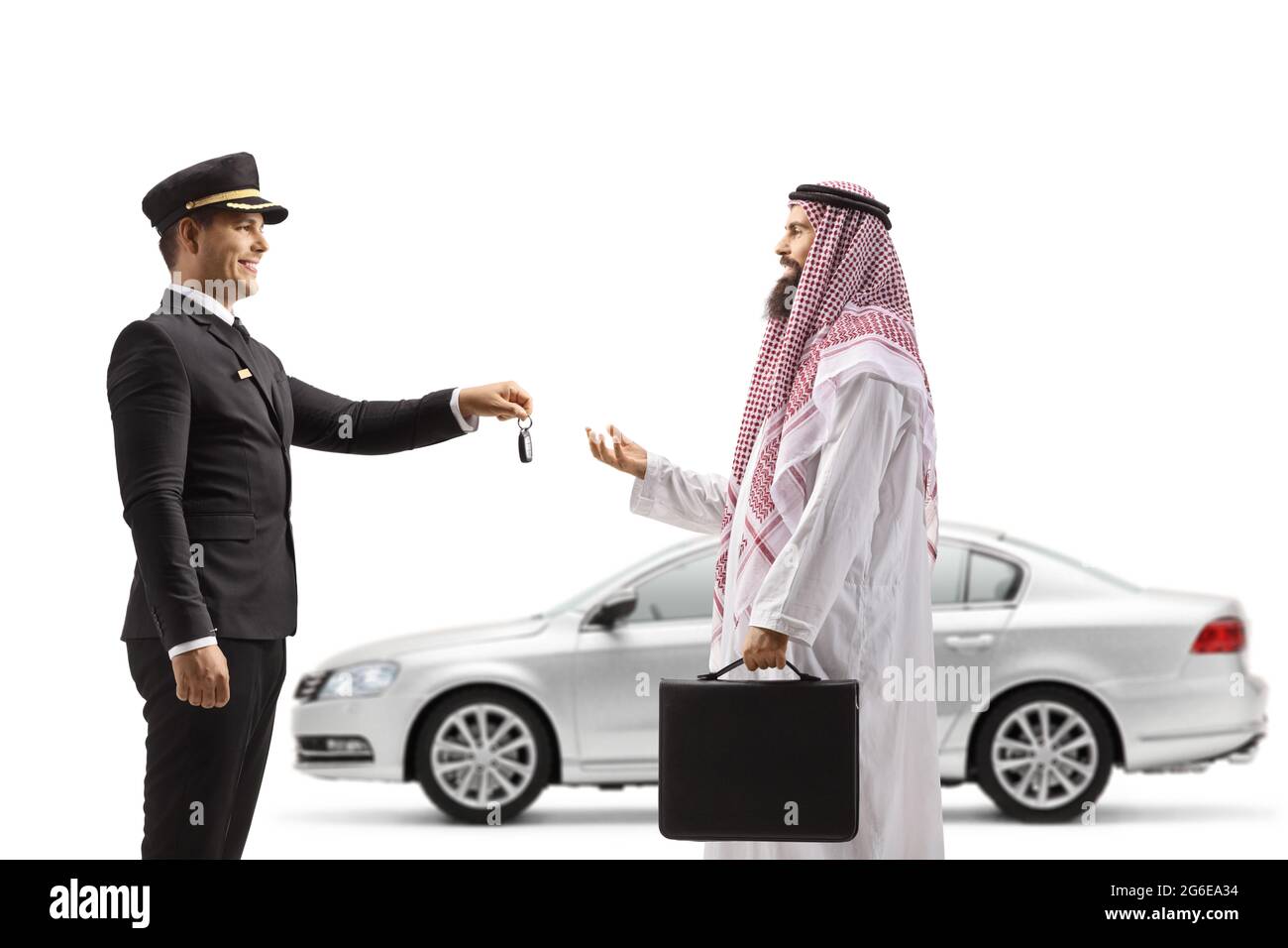 Chauffeur giving car keys from a silver car to a saudi arab man isolated on white background Stock Photo