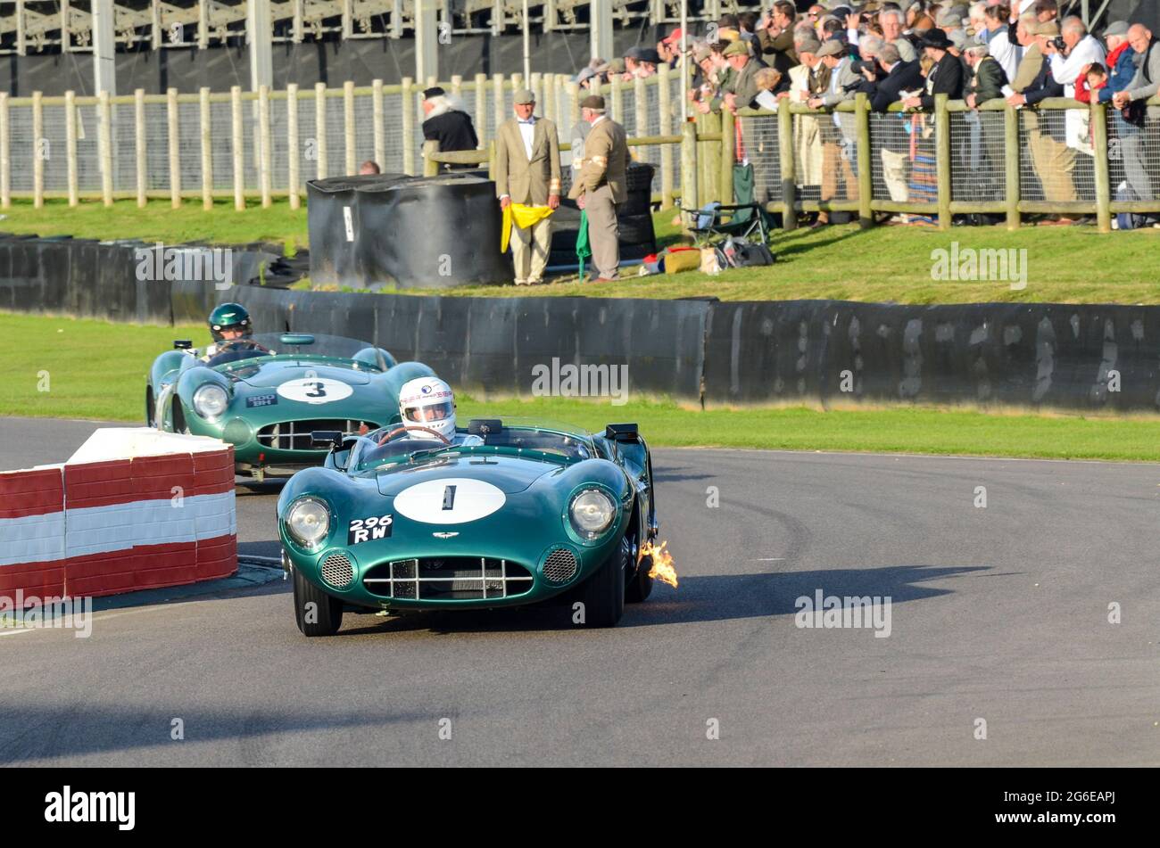 Aston Martin DBR1/1 classic sports car, vintage racing car competing in the Sussex Trophy at the Goodwood Revival historic event, UK. Exhaust flame Stock Photo