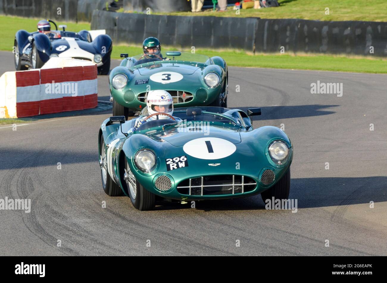 Aston Martin DBR1/1 classic sports car, vintage racing car competing in the Sussex Trophy at the Goodwood Revival historic event, UK. Cars chasing Stock Photo