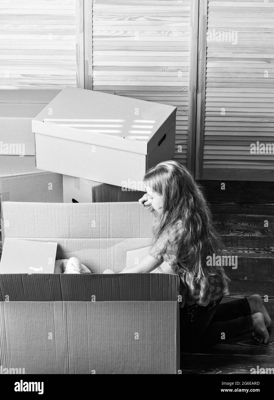 look inside. happy child cardboard box. repair of room. new apartment