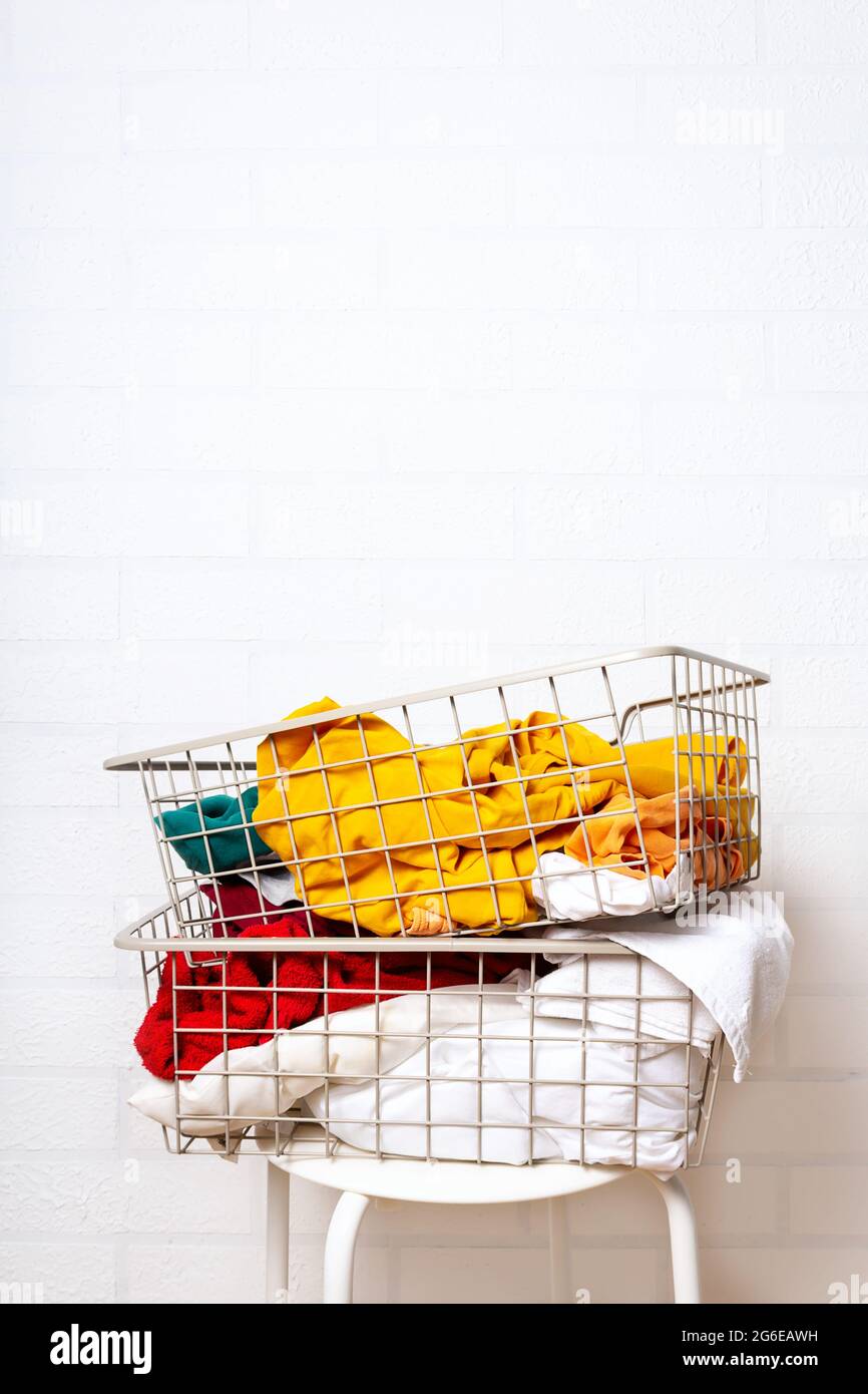 Pile of dirty, colorful laundry in baskets.  Stock Photo