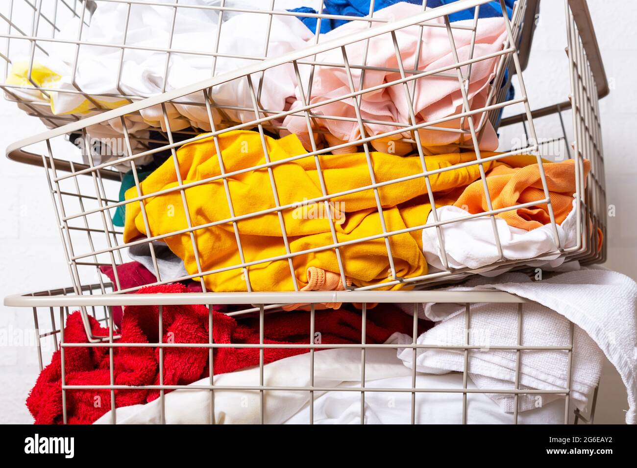 Pile of dirty, colorful laundry in baskets Stock Photo Alamy