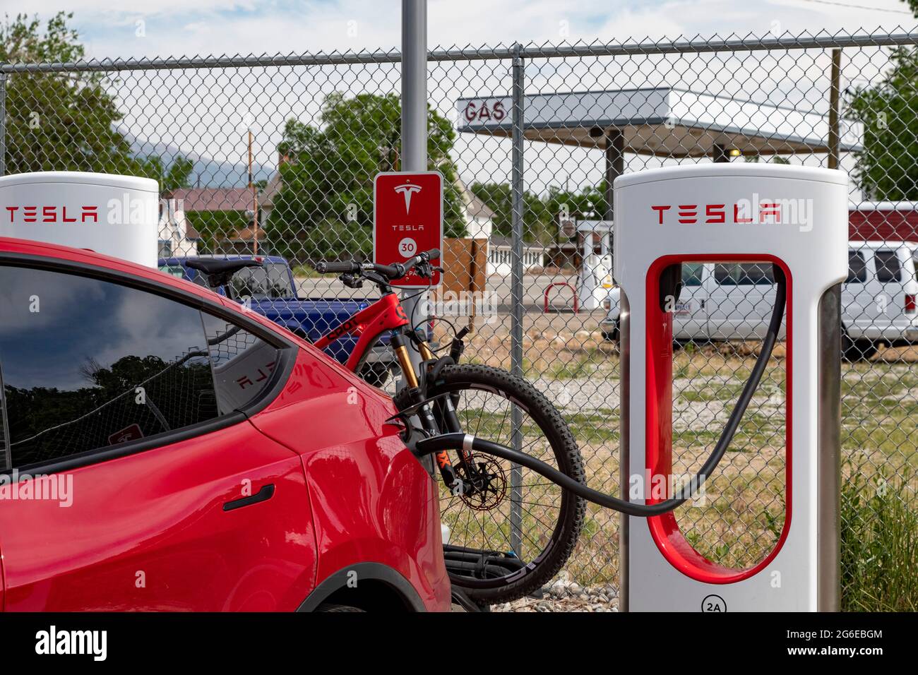 Poncha Springs, Colorado A Tesla electric car charging station, next to a traditional gas