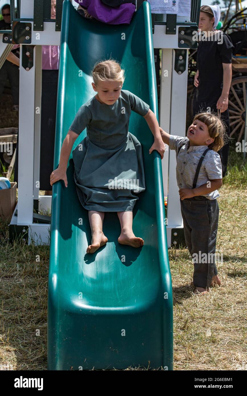 Amish children at summer carriage sale auction. Stock Photo