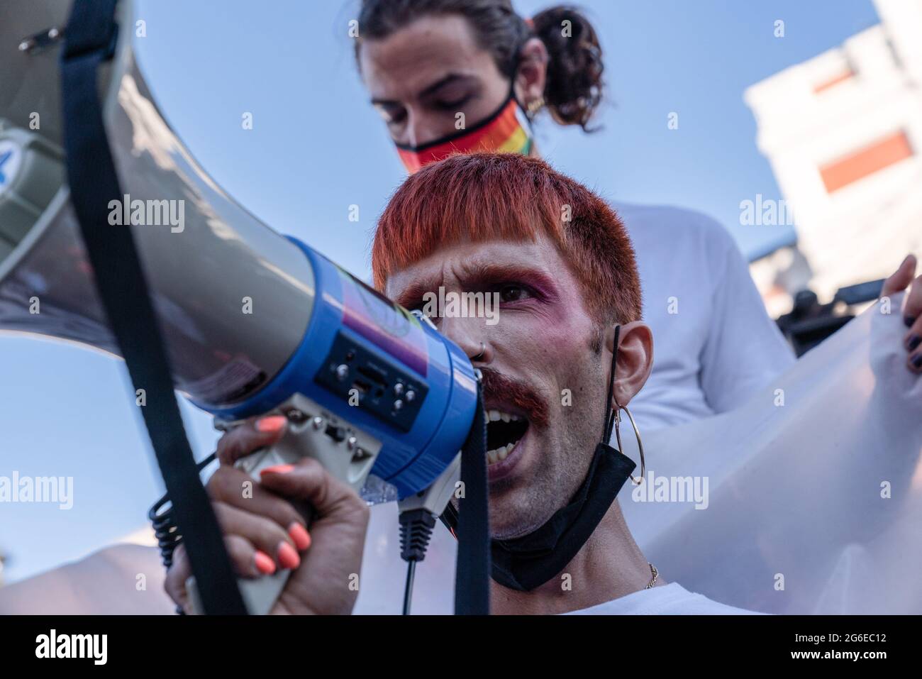 Madrid, Spain. 05th July, 2021. A demonstrator shouts their demands through a megaphone during a demonstration in Puerta del Sol. Demonstrators and the LGTBI activists demonstrate in Madrid Puerta del Sol in support of Samuel Luiz (24) who was attacked outside a night club in the Galician city of A Coruña, on Saturday morning and died from his injuries. It has been described as a homophobic crime. Credit: SOPA Images Limited/Alamy Live News Stock Photo