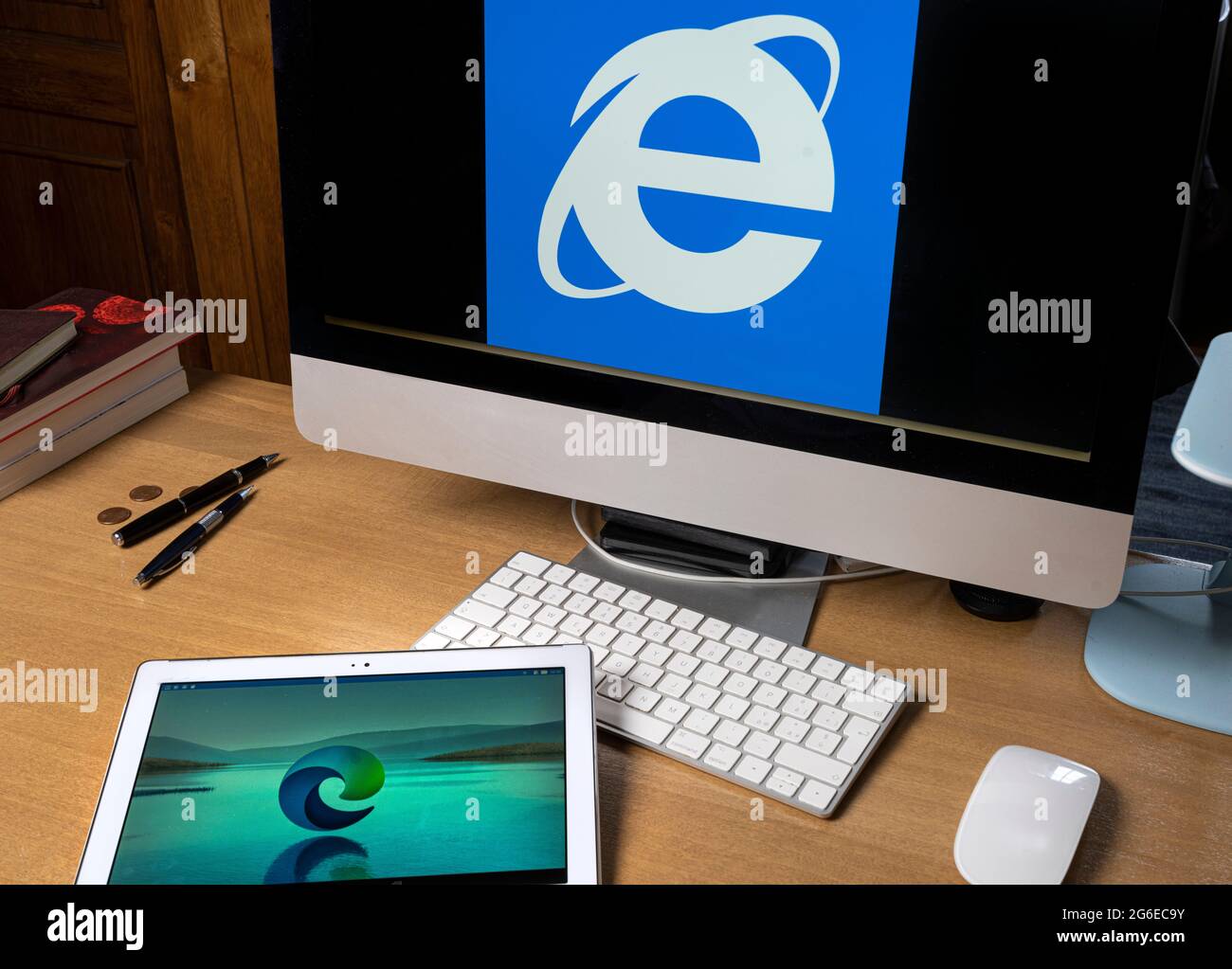 Udine, Italy, August 2021.  the symbol of the new Microsoft Edge browser on a tablet screen with the symbol of Internet Explorer on a computer screen. Stock Photo