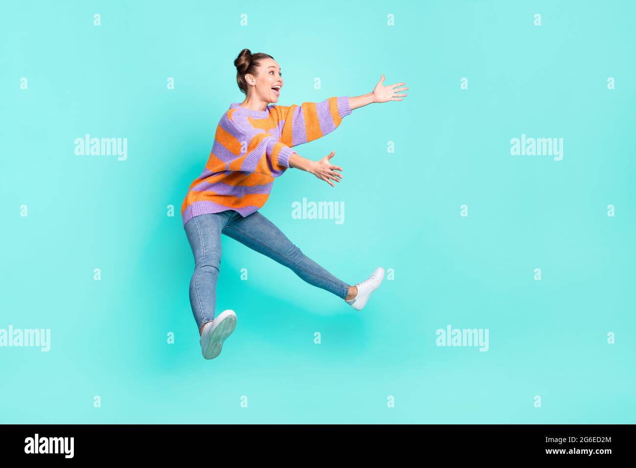 Hugging Invisable Friend Full length body size view of pretty cheerful girl jumping hugging ...