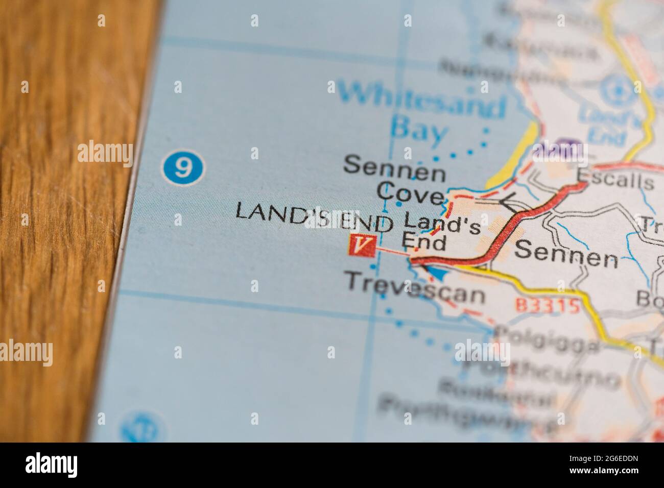 A macro closeup of a page in a printed road map atlas showing the famous landmark of Land's End headland and tourist complex in England Stock Photo