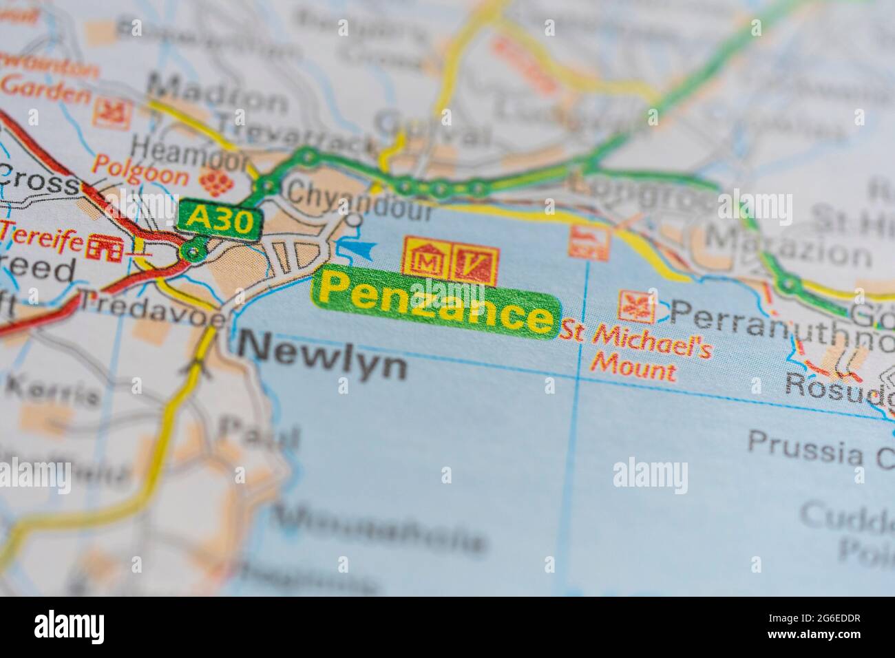 A macro closeup of a page in a printed road map atlas showing the town of Penzance in Cornwall, England Stock Photo