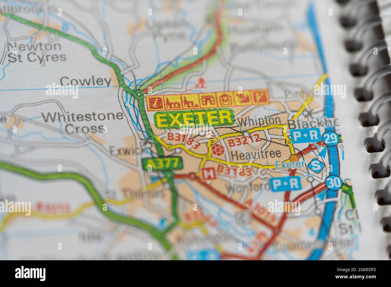 A macro closeup of a page in a printed road map atlas showing the city of Exeter in England Stock Photo