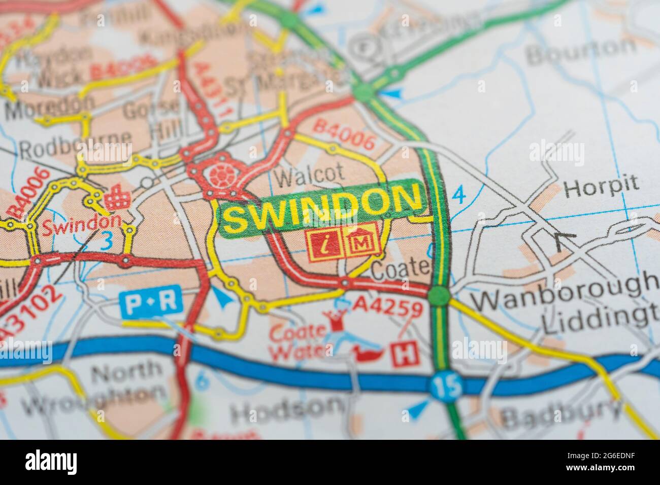 A macro closeup of a page in a printed road map atlas showing the town of Swindon in the county of Wiltshire in England Stock Photo
