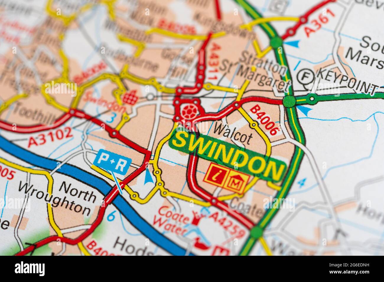 A macro closeup of a page in a printed road map atlas showing the town of Swindon in the county of Wiltshire in England Stock Photo