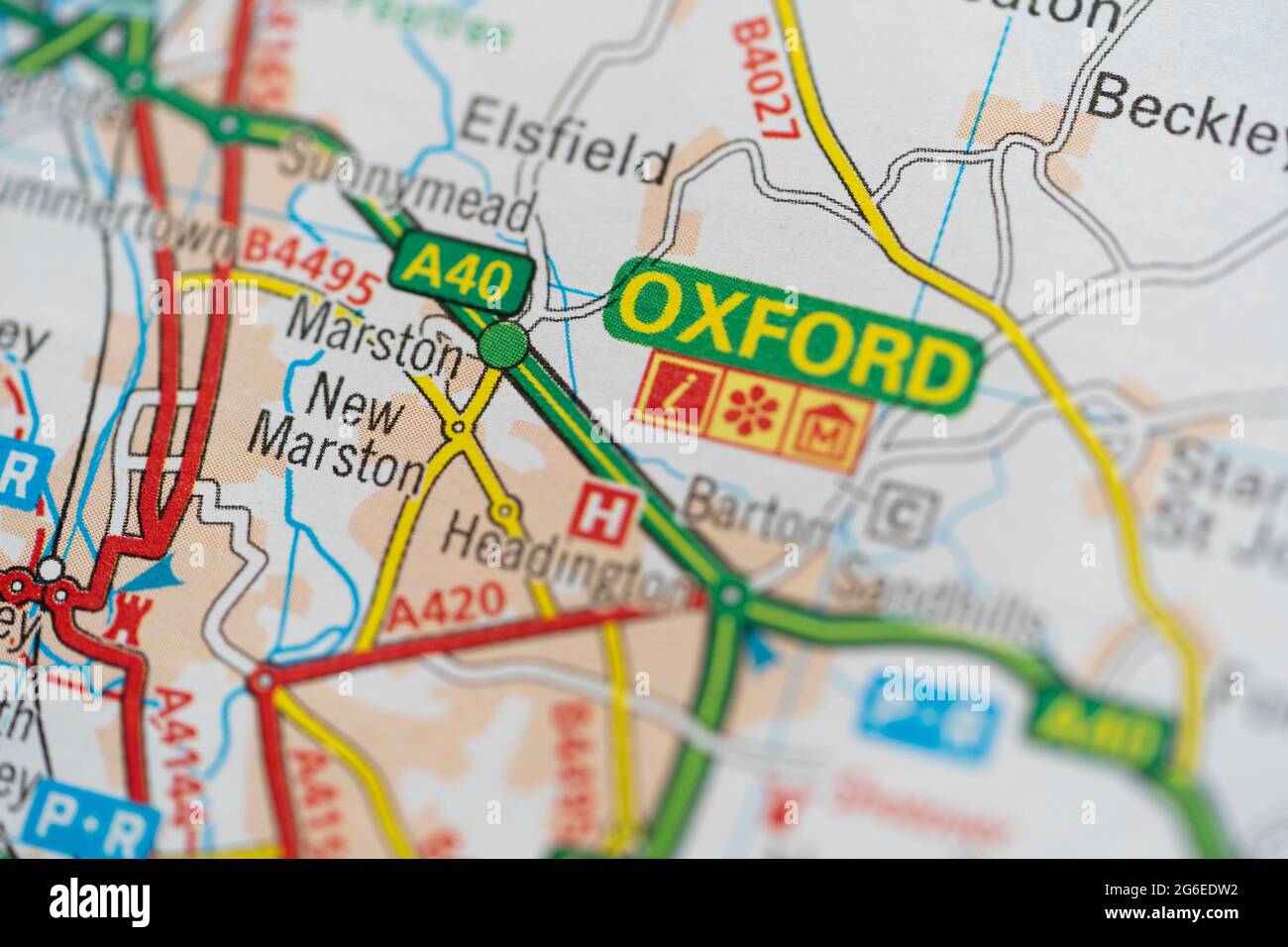 A macro closeup of a page in a printed road map atlas showing the road network and city of Oxford in the county of Oxfordshire in England Stock Photo
