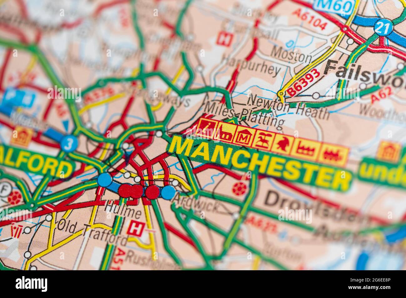 A macro closeup of a page in a printed road map atlas showing the conurbation of the city of Manchester in England Stock Photo