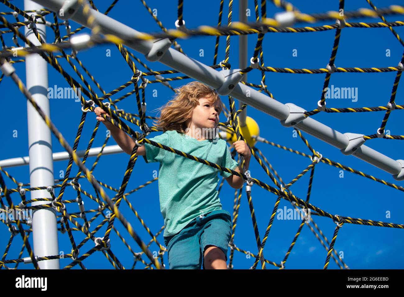 Little kid boy hanging on the monkey bar by his hand to exercise at outdoor  playground. Rope Park Stock Photo - Alamy