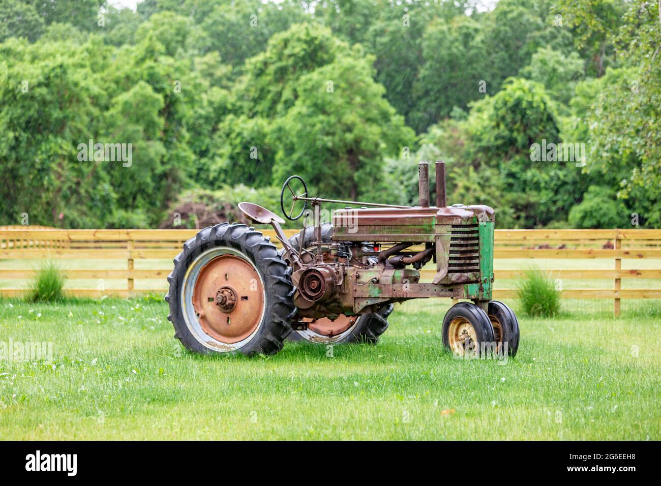 Old rusted tractor in the rain Stock Photo