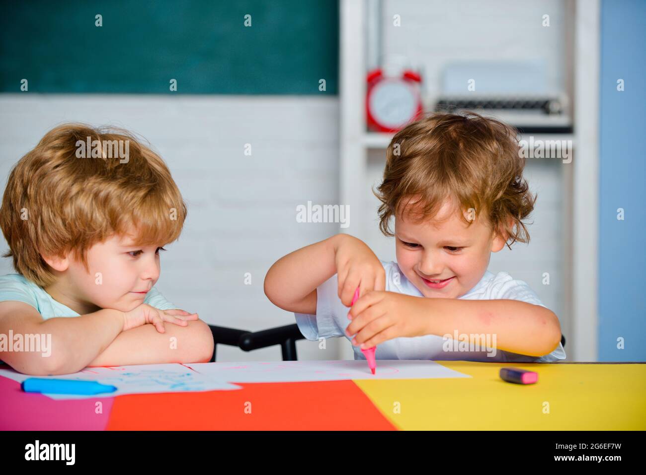 Boys Pupils from elementary school drawing at the school. Cheerful ...