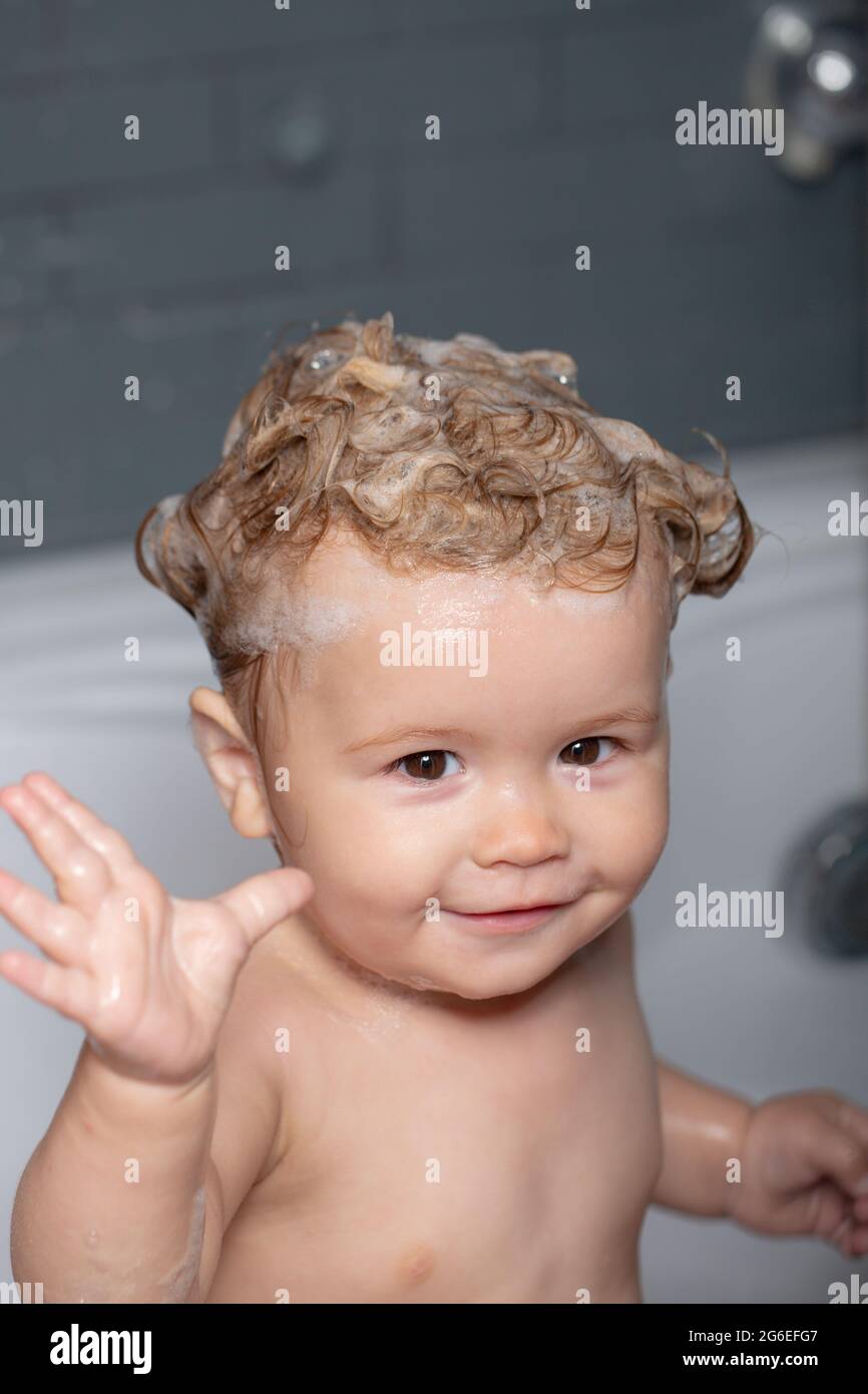 Child bubble bath. Baby bathes in a bath with foam and soap bubbles