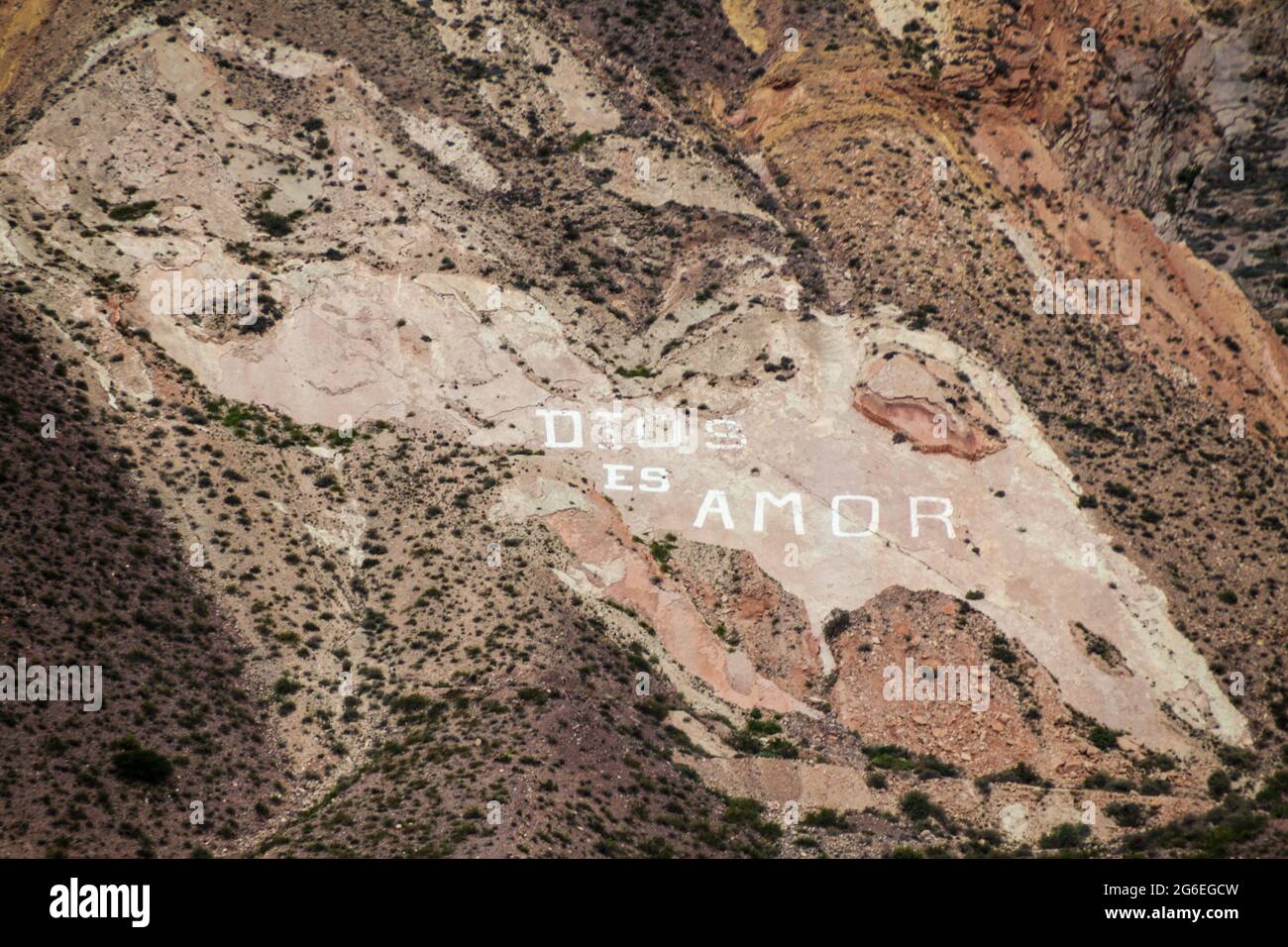 Dios es Amor (God is Love) written on a rock near village Maimara  in Quebrada de Humahuaca valley, Argentina Stock Photo