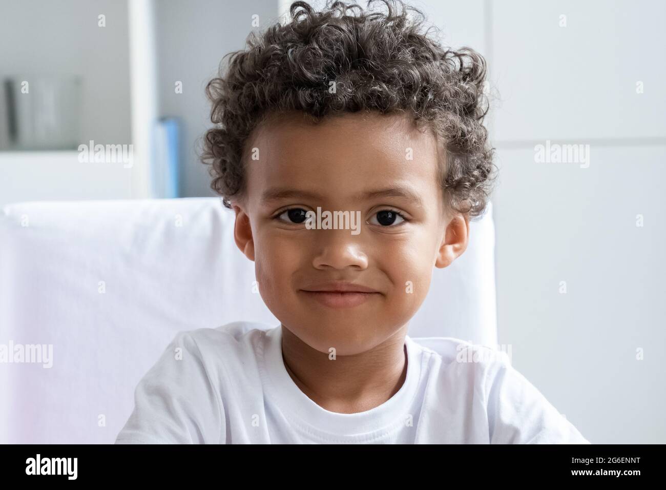 Cute smiling african american boy child looking at camera closeup portrait Stock Photo