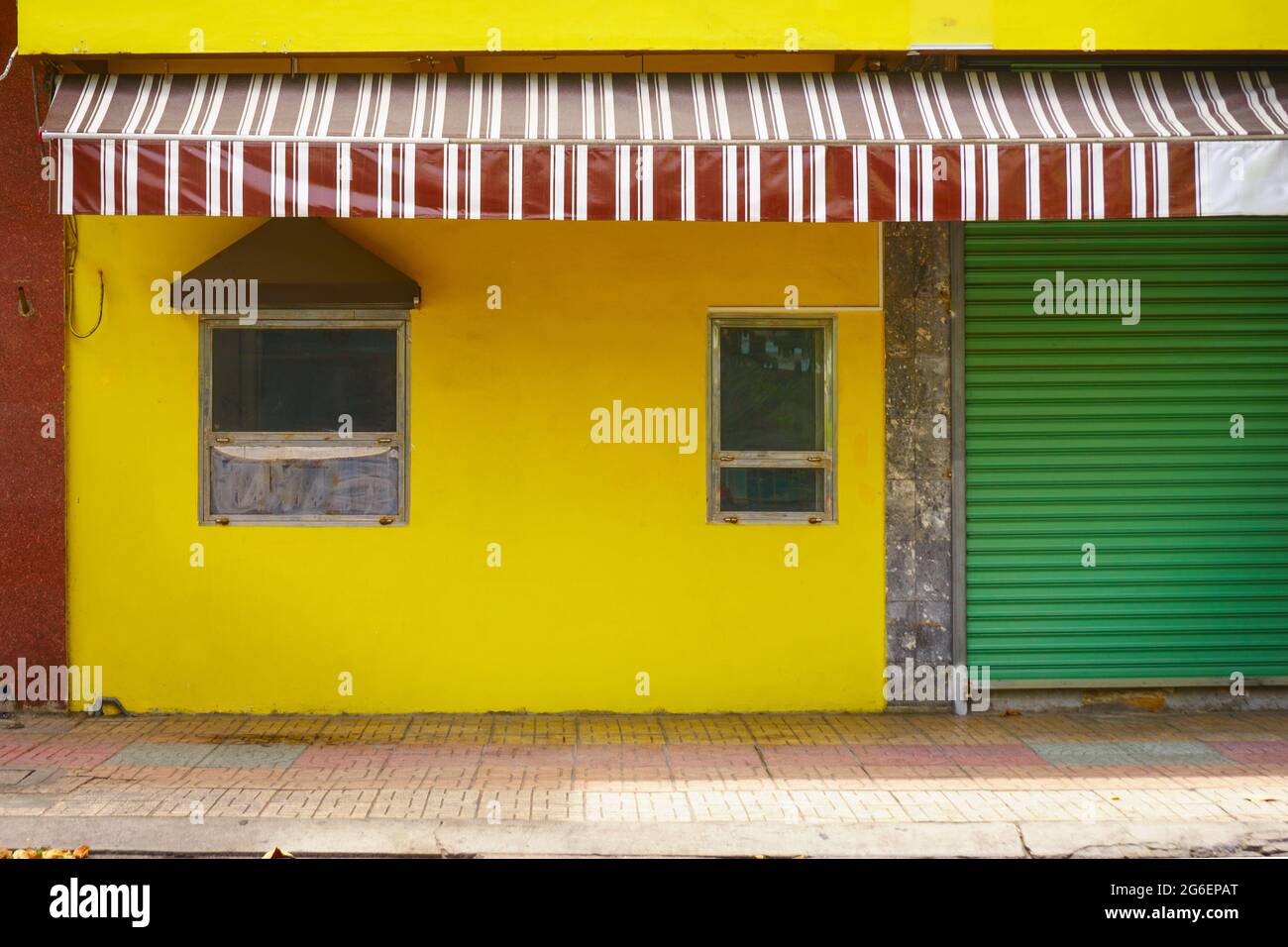 Colorful vintage facade of a house. Old building wall yellow color. Nha Trang, Vietnam Stock Photo