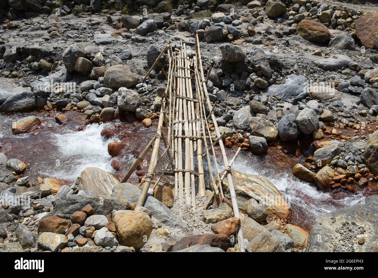 Ariel view Bamboo bridge over high current himalyan river ,the only link in remote village ,Todey , Kalimpong . Stock Photo
