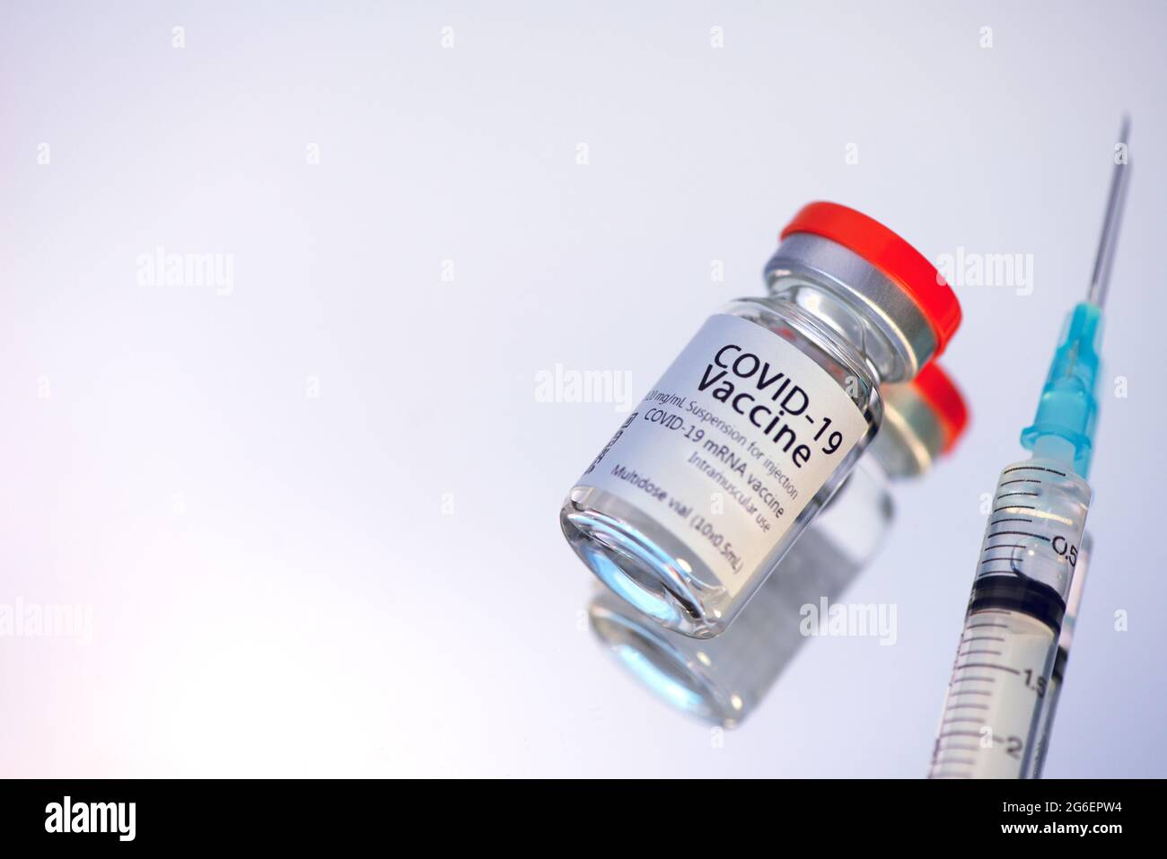 Ampoules with COVID-19 coronavirus vaccine, with a syringe for vaccination. Healthcare And Medical concept. Stock Photo