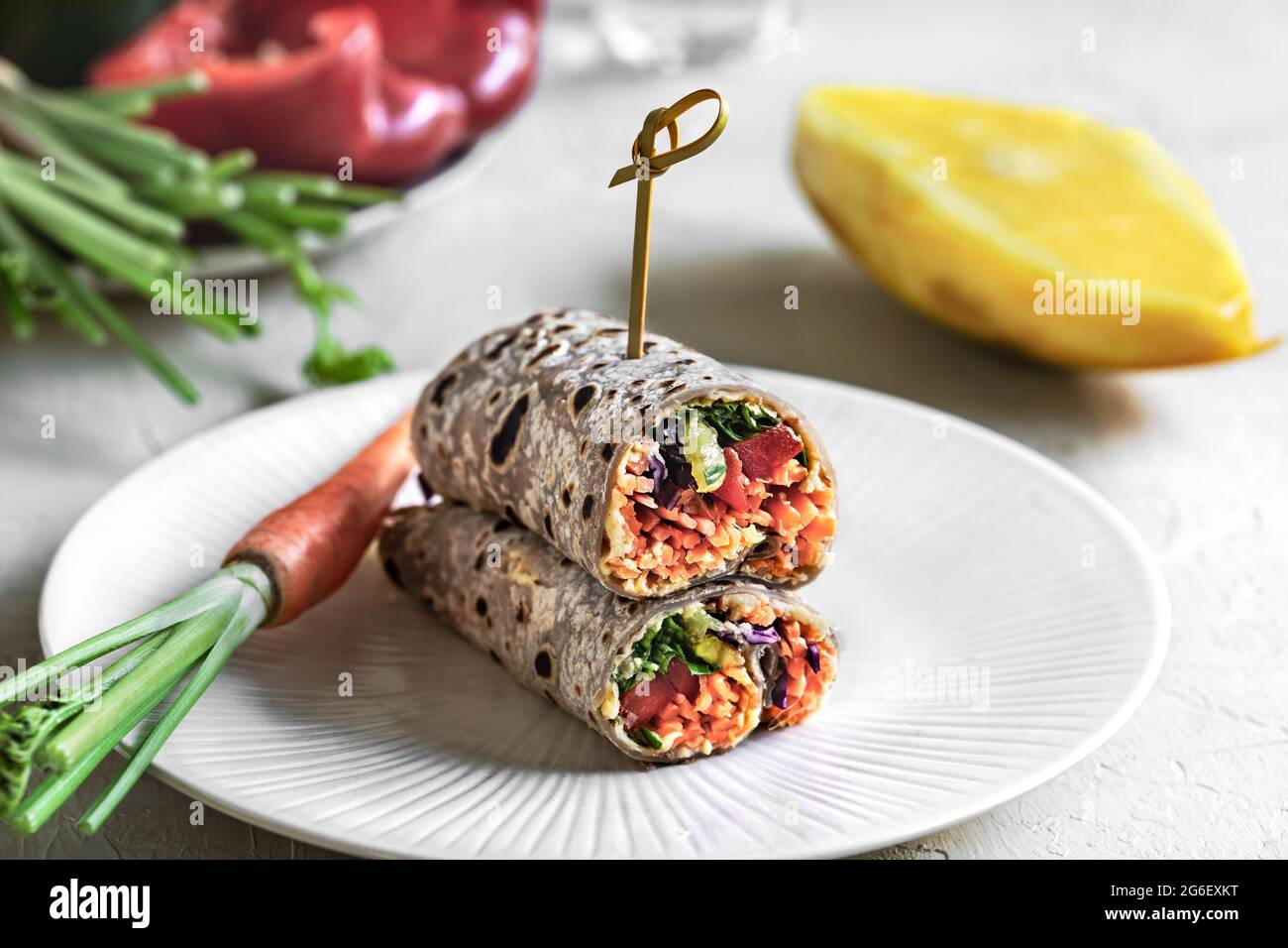 Mango Carrot Sprout and Hummus with Sweet Purple Tortilla wrap Stock Photo