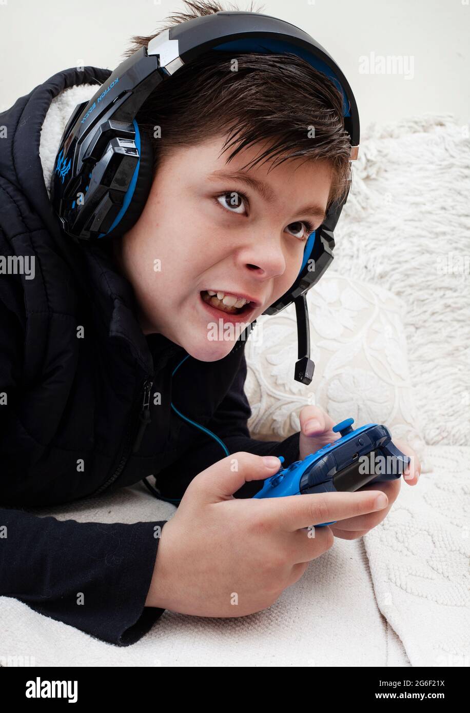 child wearing gaming headset and playing videogames Stock Photo