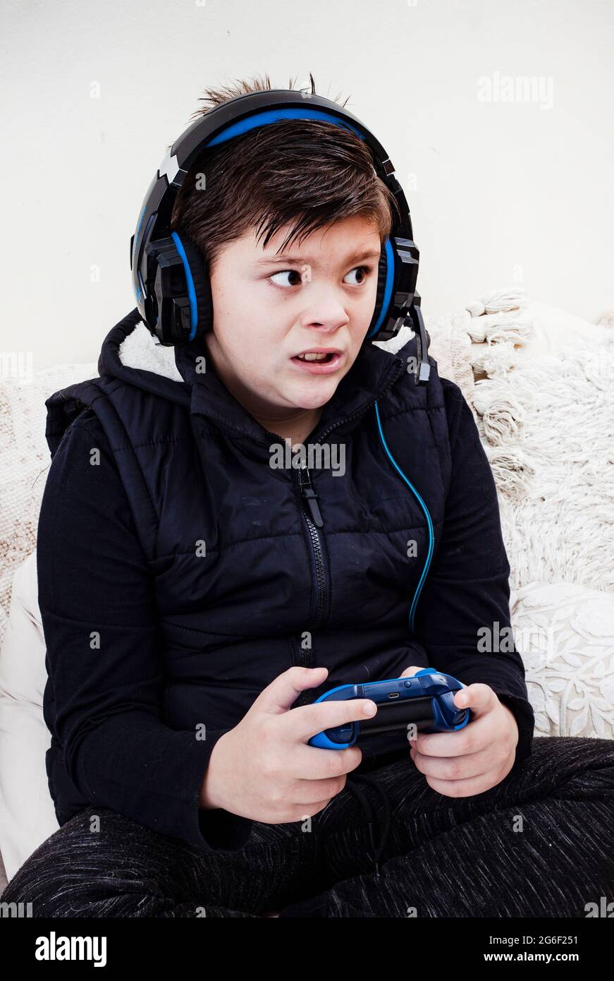 child wearing gaming headset and playing videogames Stock Photo