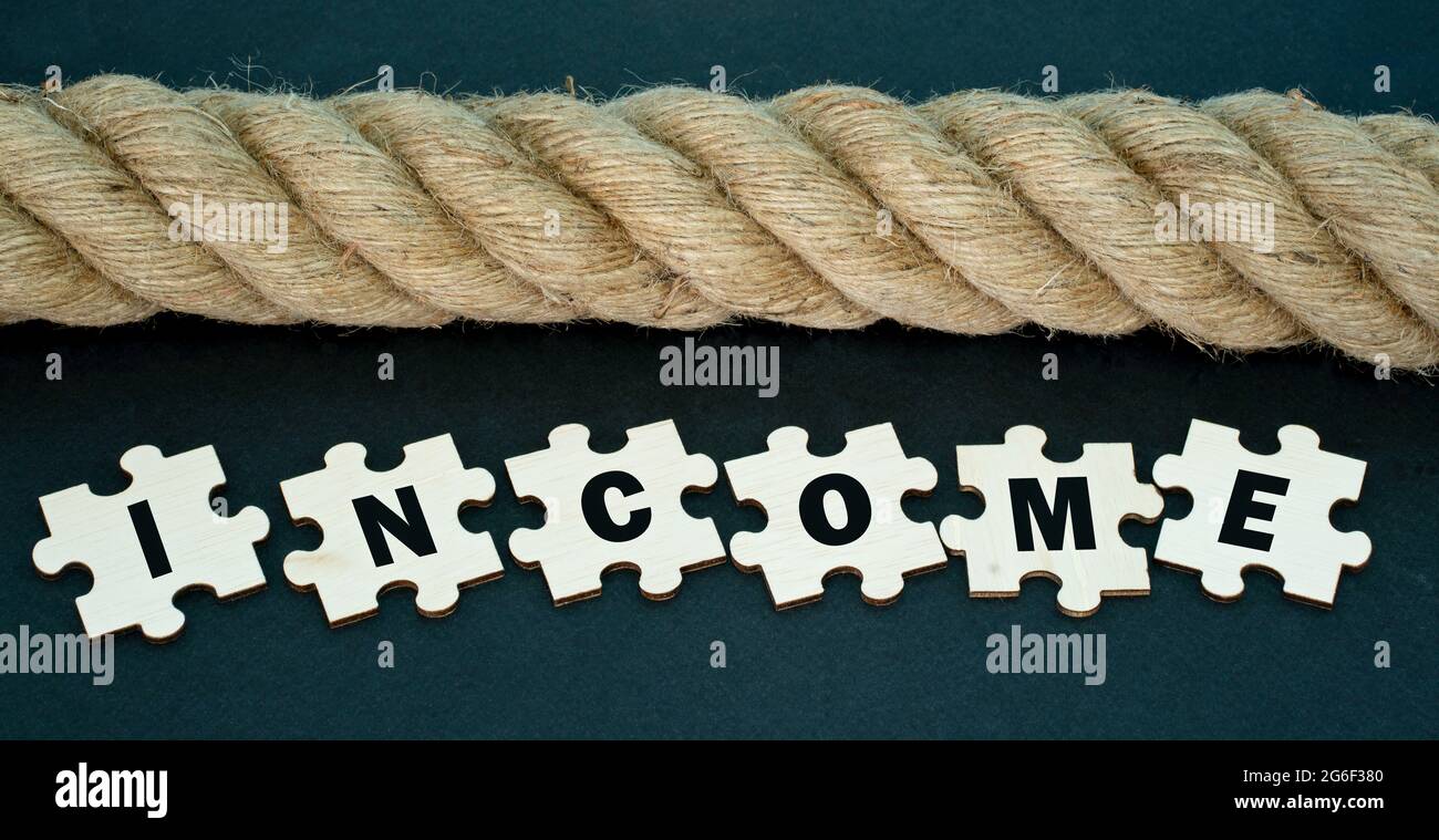 Financial concept. Rope and jigsaw tiles with text. Selective focus points. Stock Photo