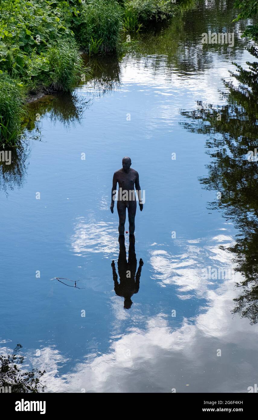 Antony Gormley sculpture in the Water of Leith at Canonmills, Edinburgh. Stock Photo