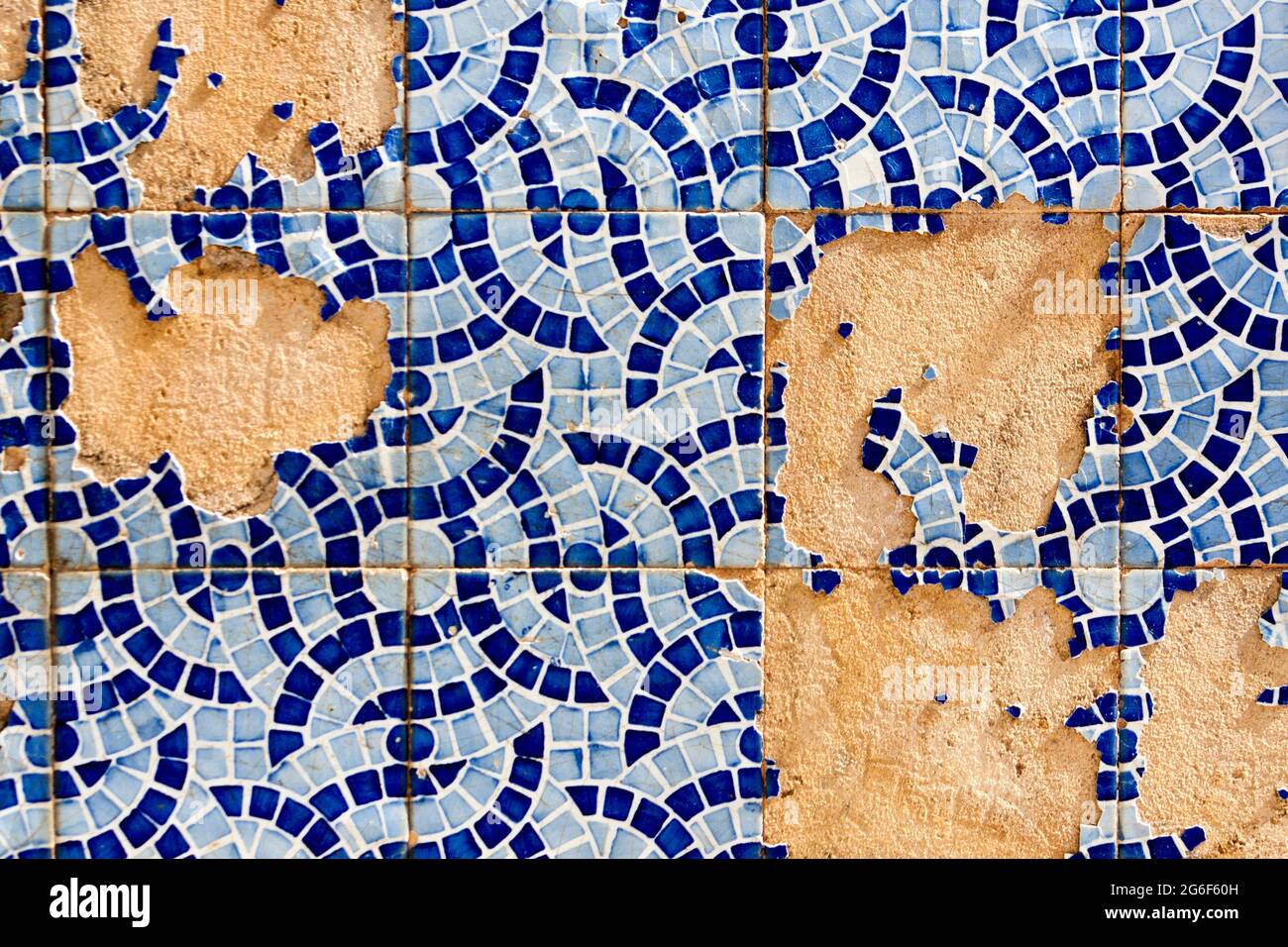 Close up view of a broken tiled wall of small azulejo. Stock Photo