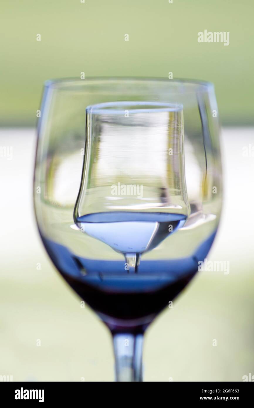 Close up view of a glass in front of another creating a visual effect. Stock Photo
