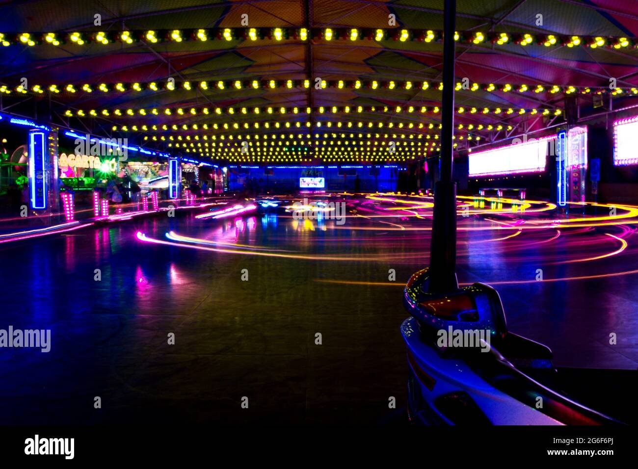 View of a amusement park bumper cars in motion at night Stock Photo Alamy