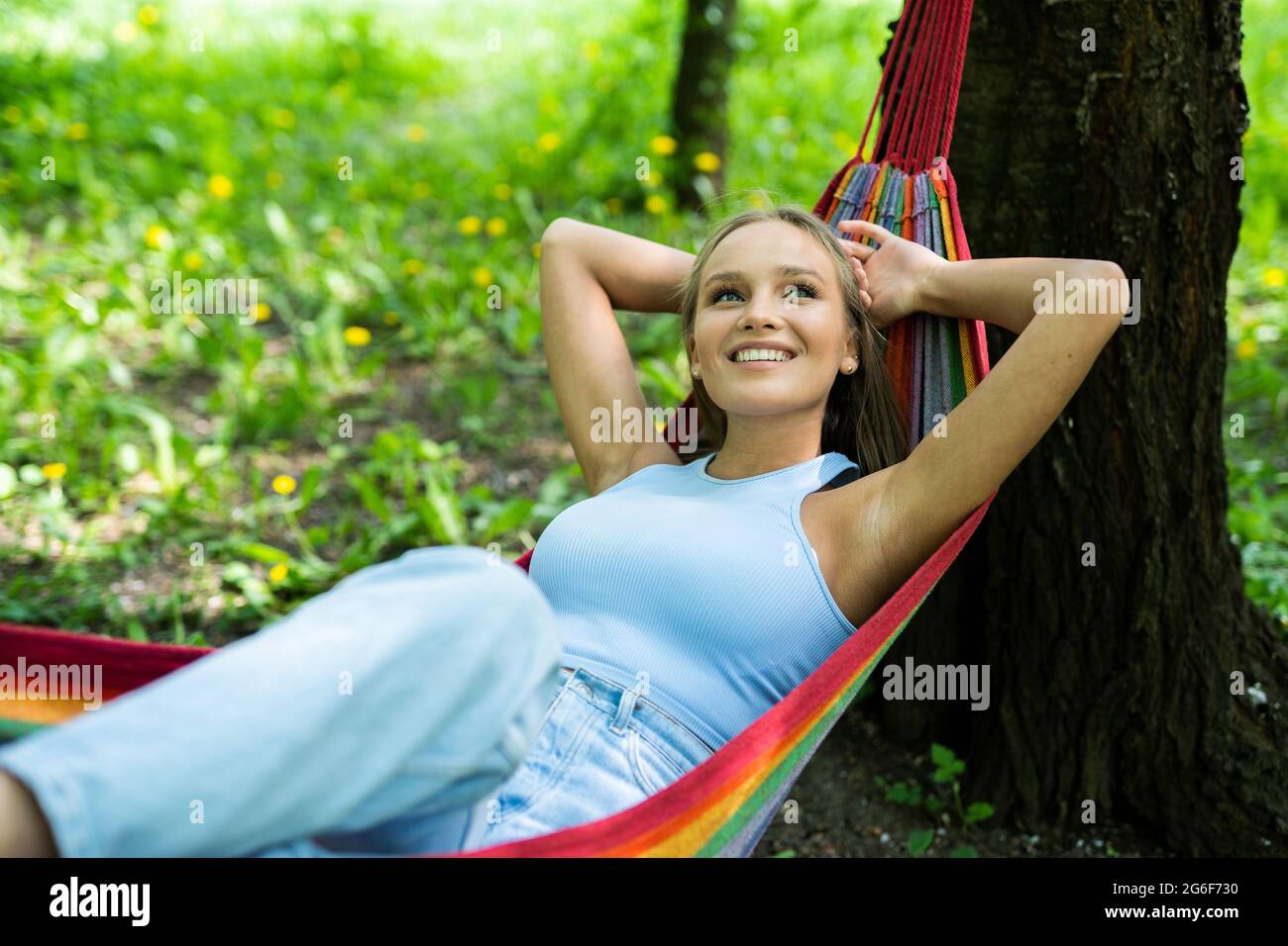 Happy young woman relaxing in hammock Stock Photo - Alamy