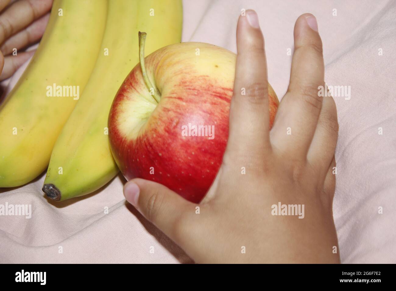 A little child eating a red apple. Stock Photo