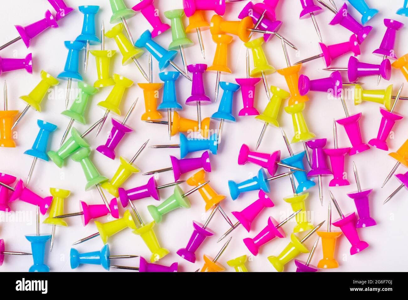 Colorful and scattered push pins on a white background Stock Photo - Alamy