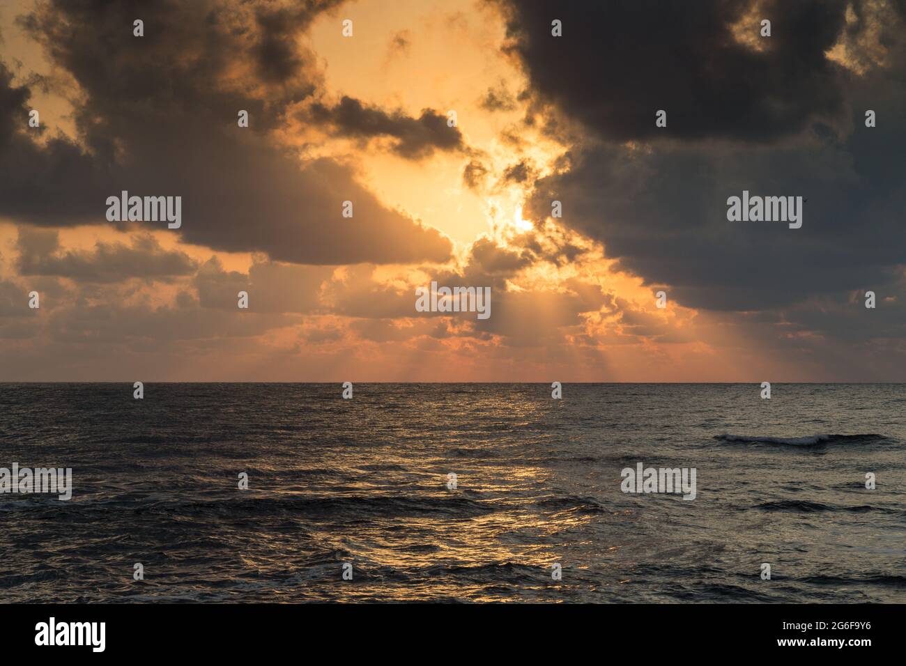 Dramatic sunrise over the sea with clouds and sun rays Stock Photo - Alamy