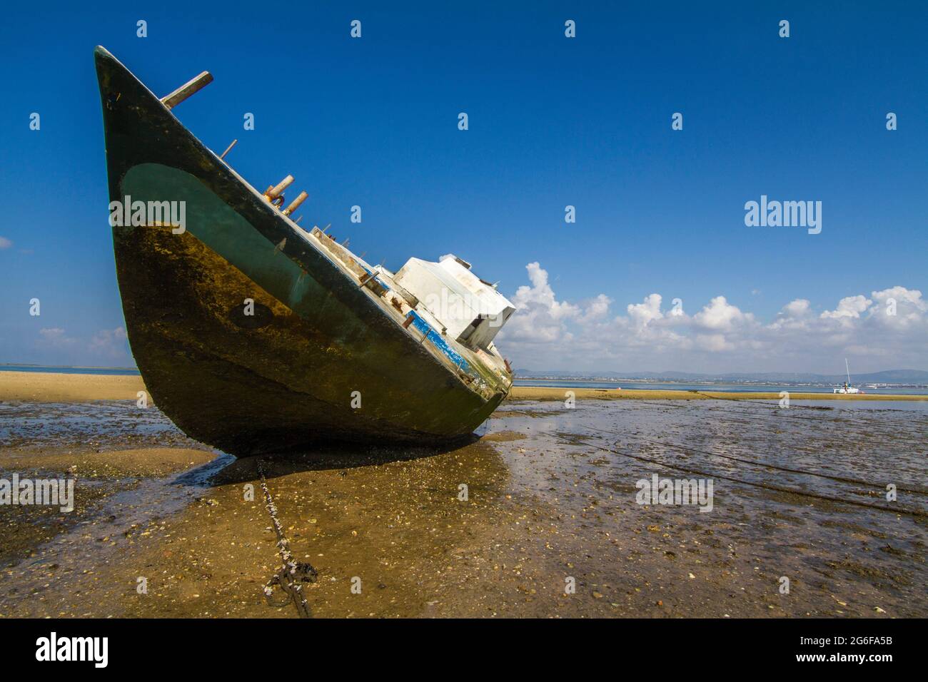 View of an old abandoned boat stranded on dry sand at the beach Stock ...