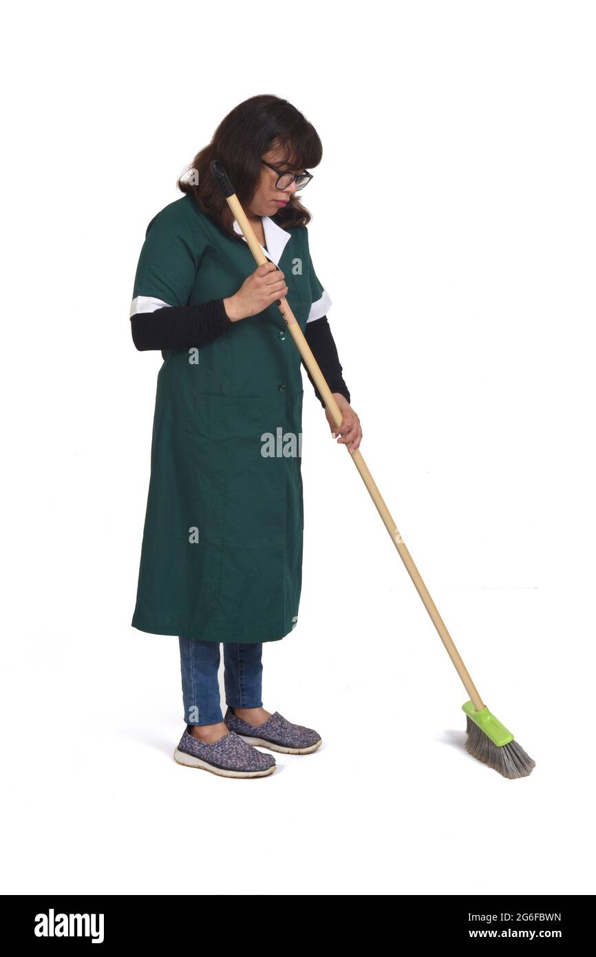 side view of a cleaning woman who is sweeping over white Stock Photo
