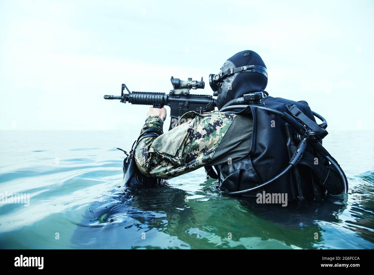 Navy SEAL frogman with complete diving gear and weapons in the water