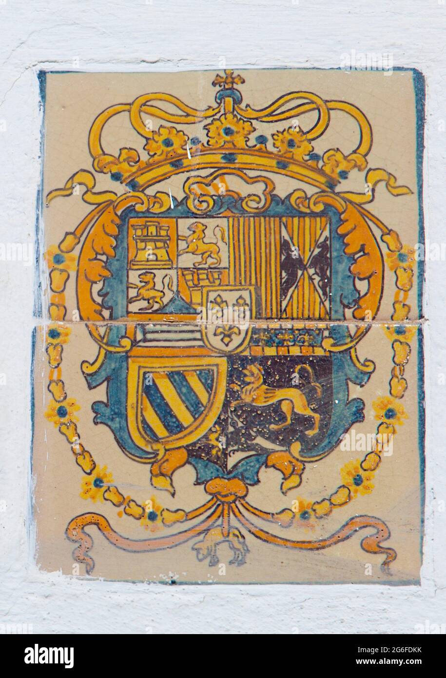 Royal Alcazars of Seville. Coat of arms glazed tiled from Patio de Banderas Section. Stock Photo
