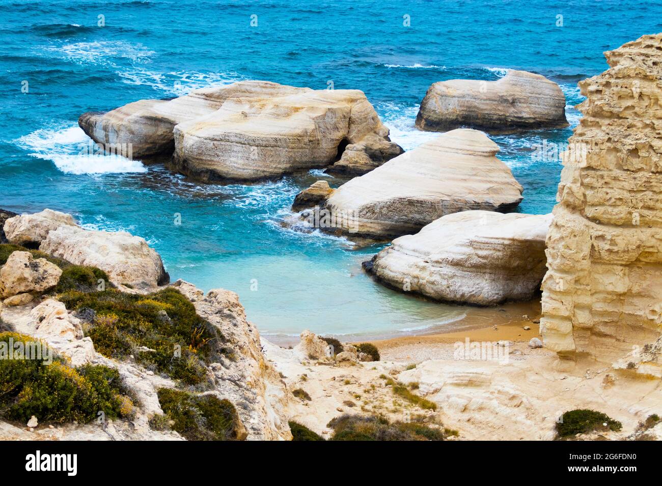 Ocean waves splash against beach with rocks background, Cliffs in the sea, Top aerial view of
